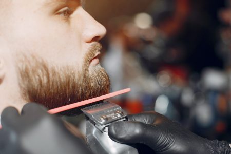 Man with a beard. Hairdresser with a client.
